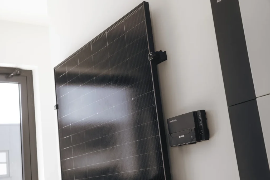 Zonnepaneel met omvormer aan de wand